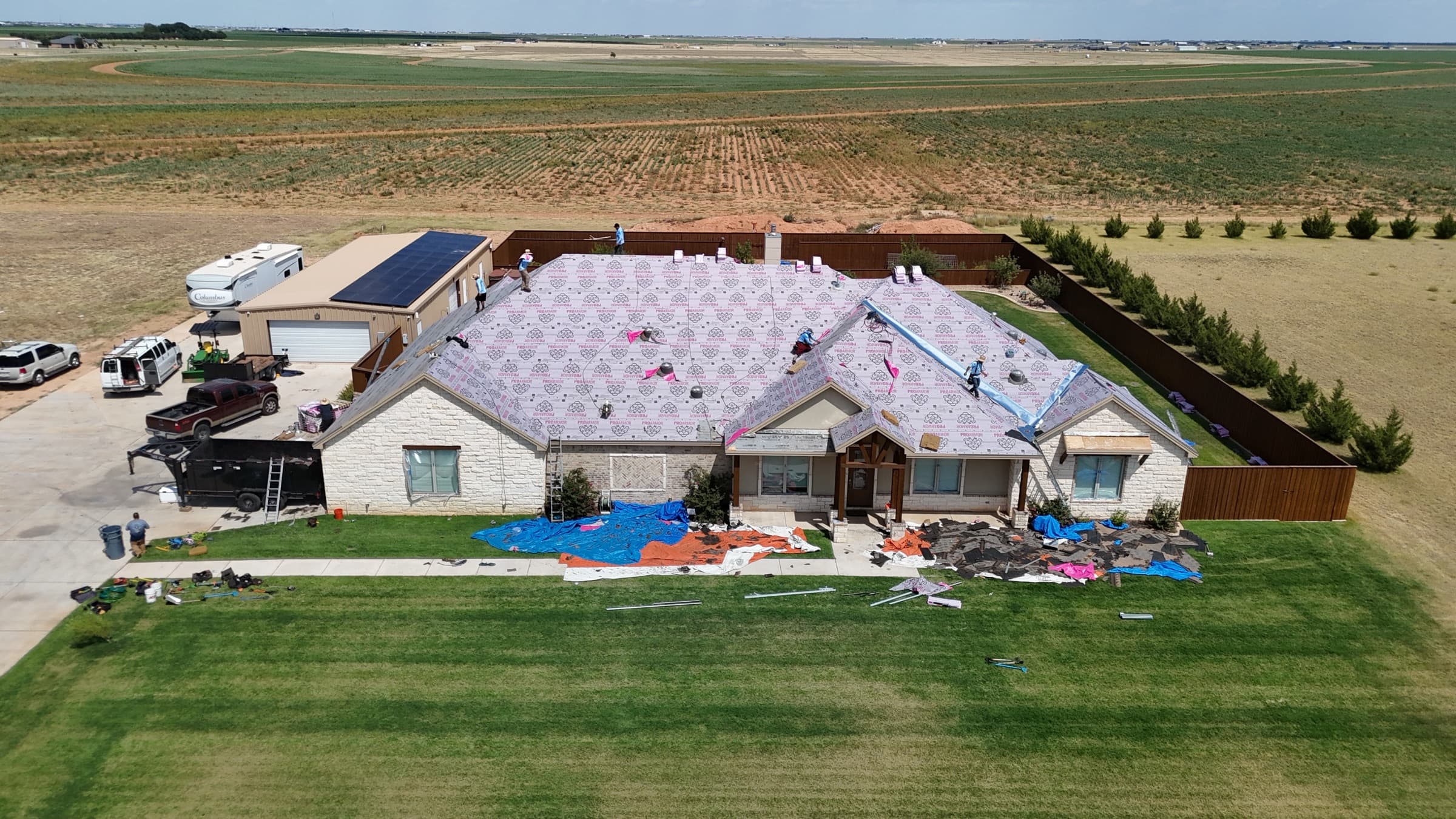 New construction roof installation — aerial drone shot